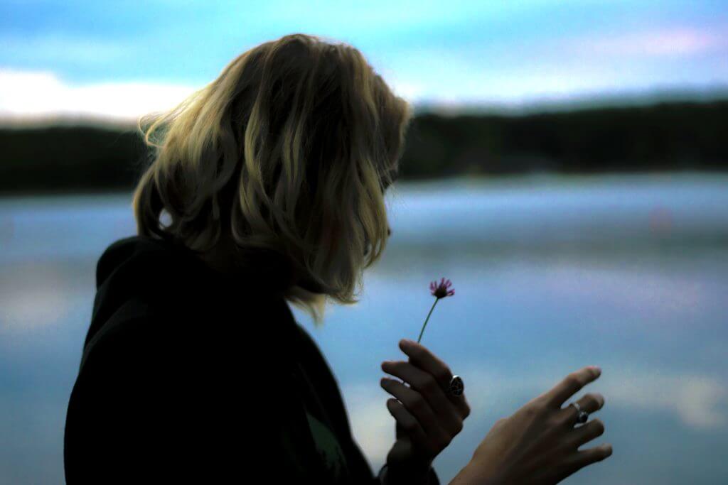 woman holding a flower